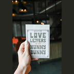 A person holding 150 Love Letters for Your Hunny Bunny Book