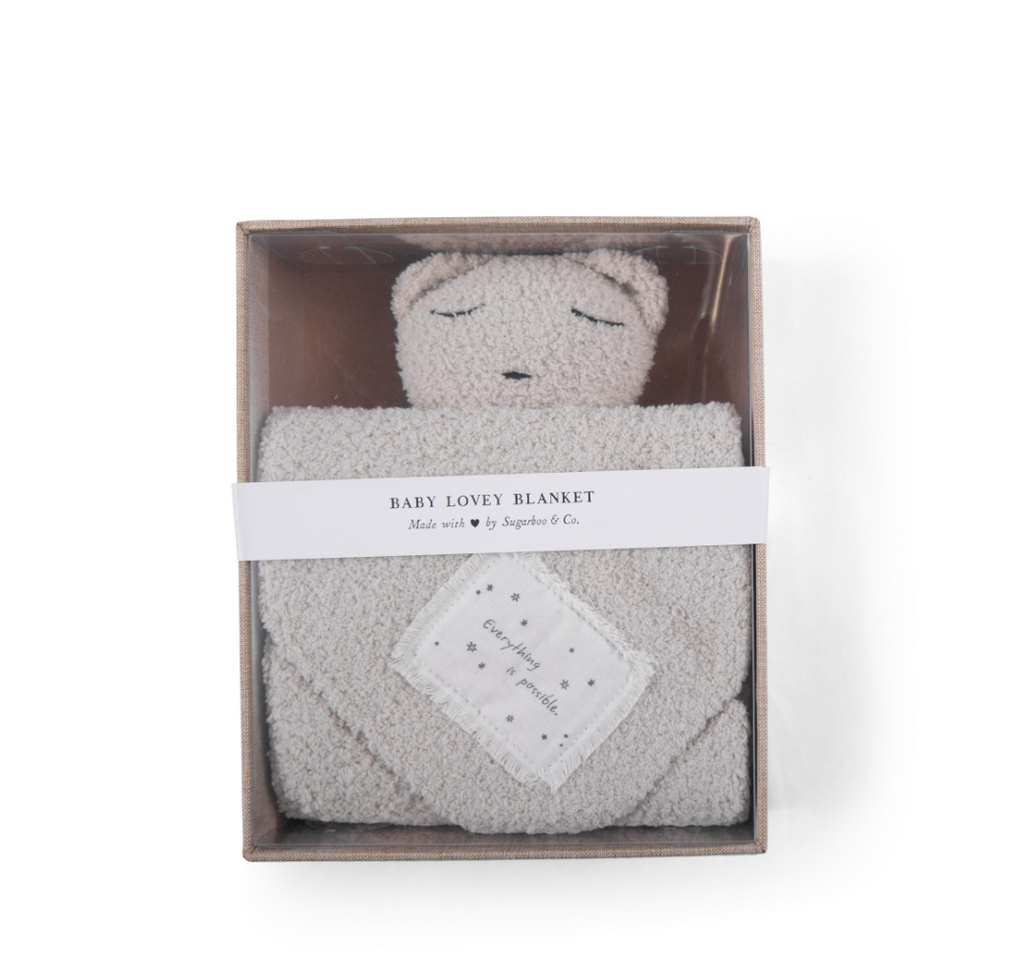 a white Bear Baby Lovey Blanket in a box
